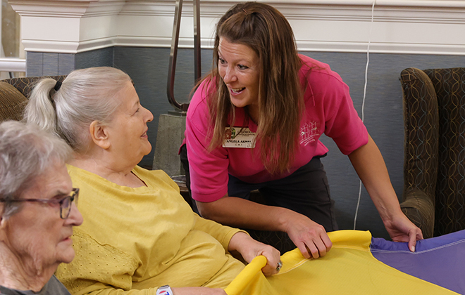 resident smiling with staff